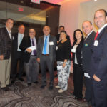 business professionals pose for a picture during the Long Island Hospitality Association 2018 kick off meeting